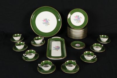 green and white porcelain dinnerware set with matching cups and saucers
