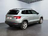 the rear end of a silver volkswagen suv parked in a garage