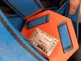a person that is holding a blue bag with a tag attached to it