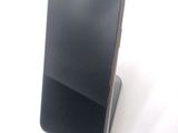 a cell phone that is sitting on top of a stand