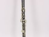 a close up of a clarinet on a white surface with a white background