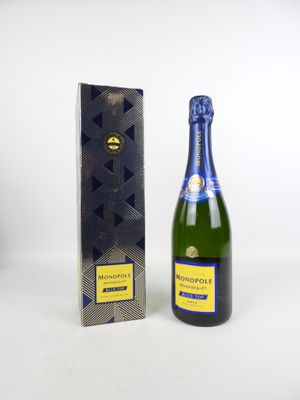 the bottle of champagne is next to a box of chocolates