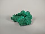 green mineral on a white surface with a white background