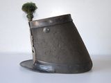 a small potted plant sitting on top of a hat