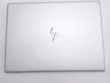 the hp laptop is sitting on a white surface with a small logo on it
