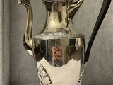 a silver tea pot that is sitting on a table