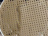 a close up of a chair with holes in the seat