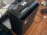a paper shredder sitting on top of a wooden desk