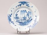 a blue and white plate with a bird on it