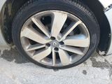 tire of a white car with a flat tire on the side of the road