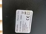 a close up of a black electronic device on a white surface
