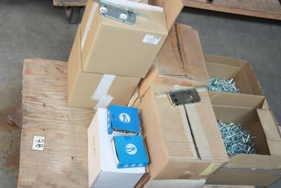 many boxes of screws and screws sitting on a pallet