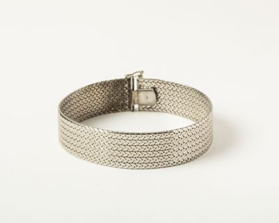 a close up of a silver bracelet on a white background