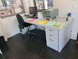 a desk with a computer and a printer on it