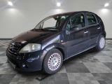 a picture of a small black car parked in a garage