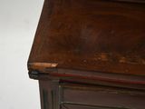 a wooden cabinet with a drawer on top of it