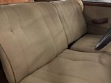 an old car that has a seat in the back
