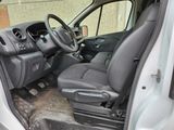 the interior of a car with the door open and the driver ' s seat down
