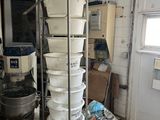 many buckets stacked on top of each other in a kitchen