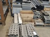 many pieces of metal on the floor in a warehouse