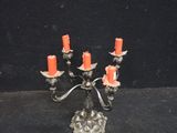a silver candelab with orange candles on it