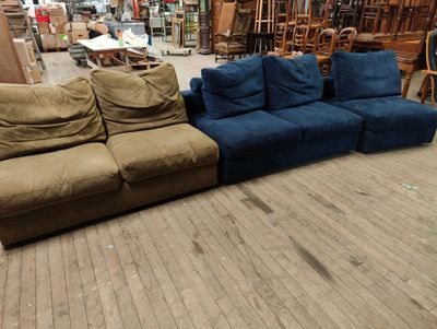 two couches that are sitting on the floor in a room