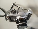 a silver camera sitting on a table next to a toothbrush