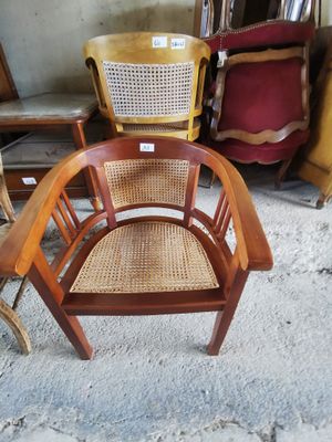 a chair that is sitting in the middle of a pile of chairs