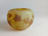 a small glass bowl with a gold leaf design on it
