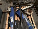 several skis and ski poles are on a pallet in a warehouse