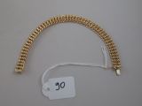 a gold chain bracelet with a price tag attached to it