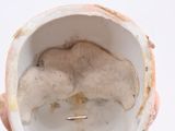 a hand holding a cup that has a hole in it