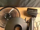 a picture of a table with a fan and other items on it