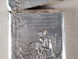 two silver lighters with a picture of a man and a woman on them
