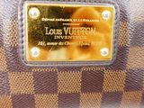 a close up of a louis vuitton purse on a white background