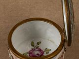 a small cup with a lid sitting on a table