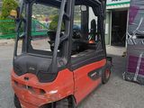 a red fork truck parked in front of a building