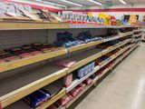 shelves in a grocery store filled with lots of different types of food