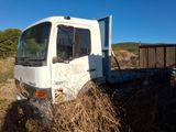 a white truck that is parked in a field
