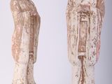 three statues of asian people are standing next to each other on a white surface
