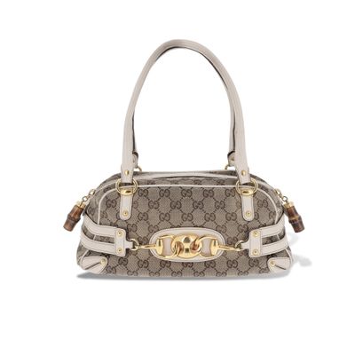 un sac à main marron et blanc orné d'une boucle dorée
