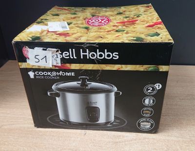 the box of the crock pot is open on the table