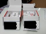 two boxes that have ipods inside of them on a table