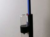 a blue and black device with a glass in it