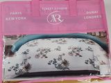 packaging of a pink purse with a floral pattern on it