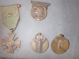 three medals and a medal on a table with a ribbon