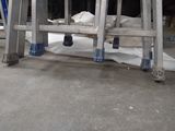 a ladder that is sitting on the floor in a room