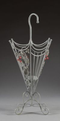 a metal umbrella stand with an umbrella on it
