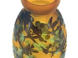a yellow vase with a blue and green design on it