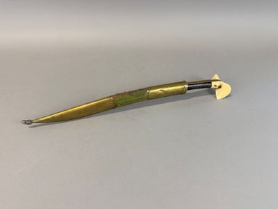 a gold colored pen that is laying on a white surface